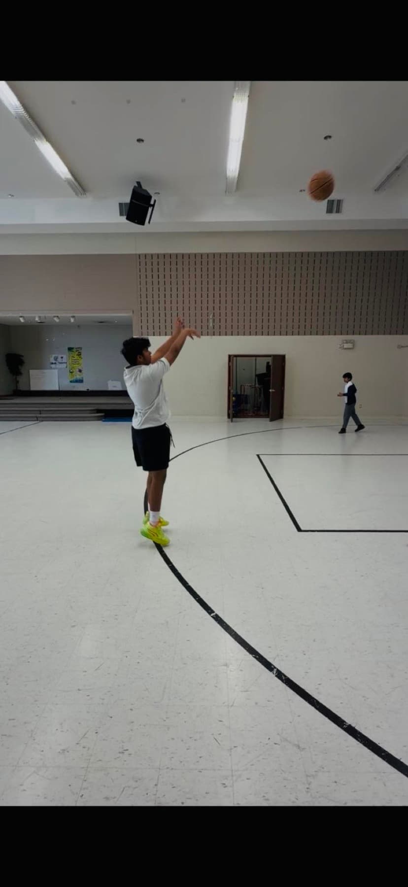 Mir Kahol shooting a jump shot in a gym, ball in the air